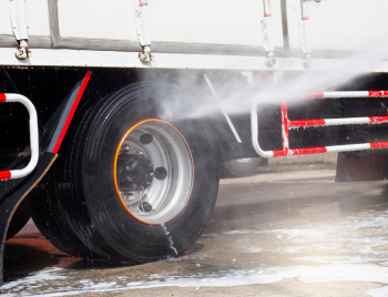 Pressure washing a commercial truck in Lakewood, CO fleet yard