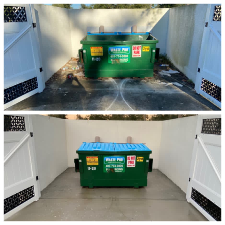 Technician power washing trash area behind Denver restaurant
