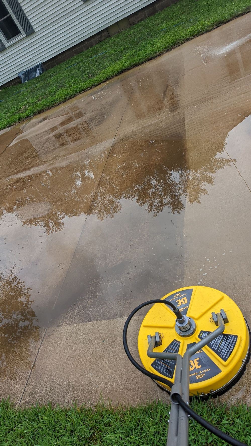 "Before and after driveway power washing by JJ Power Washing in Denver, CO – removing grime and restoring clean concrete surface."